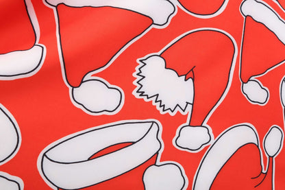 Kerstjurk voor dames met zwart lijfje, lange mouwen en rode rok met kerstmutsen