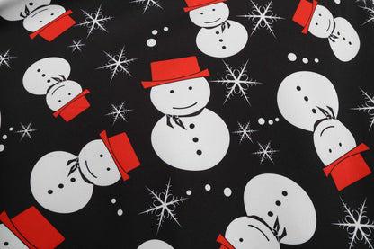 Zwarte vintage kerstjurk met geschulpte V-hals en sneeuwpoppenprint op de rok