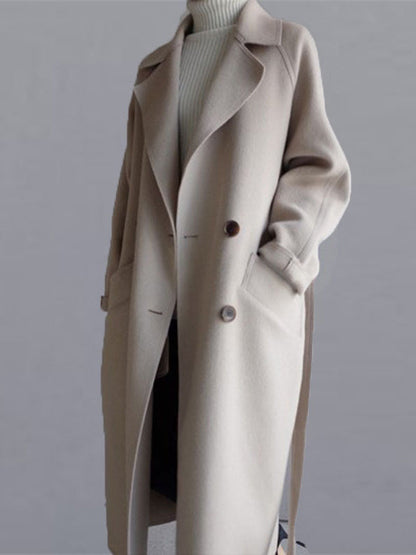 Lange jas dames met ceintuur, revers en paspelzakken - beige