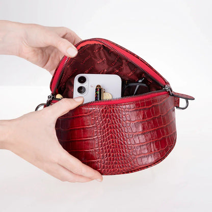 Donkere crossbody tas met krokodillenprint, achterzijde met D-ringen