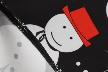 Zwarte vintage kerstjurk met geschulpte V-hals en sneeuwpoppenprint op de rok