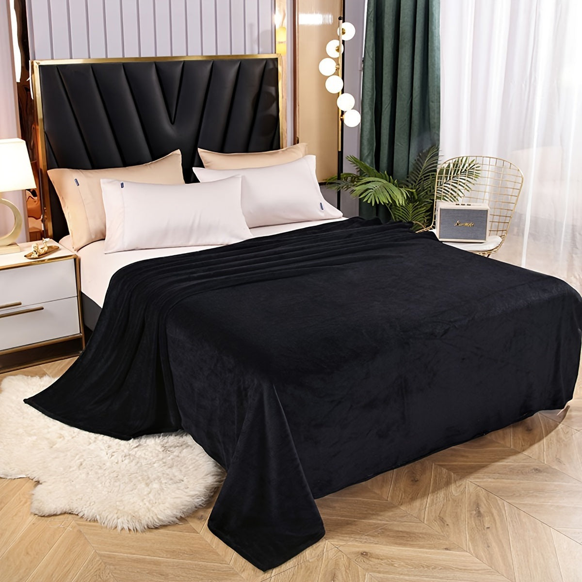 Effen fleece deken van flanel over een bed - zwart