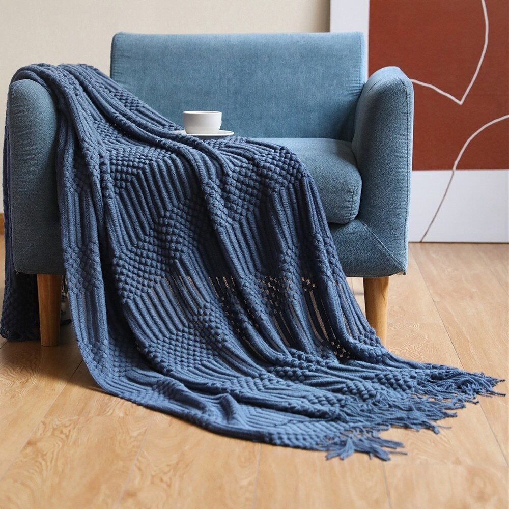 Gebreide plaid met Scandinavisch patroon en franjes over een stoel - donkerblauw