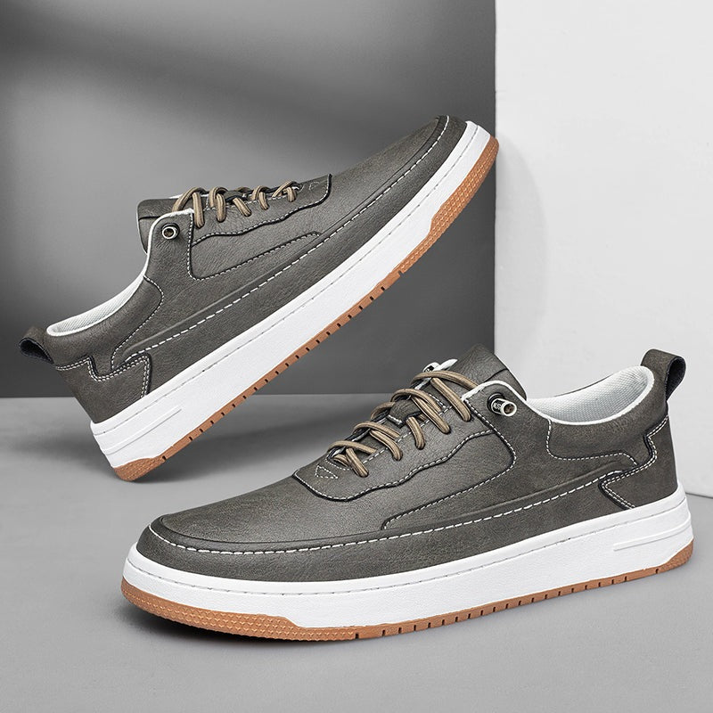 Lage herensneakers in leerlook met contraststiksel, witte zool en bruine loopzool - grijs