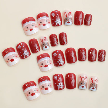 Kerst plaknagels met kerstprint, opgeplakt op een hand