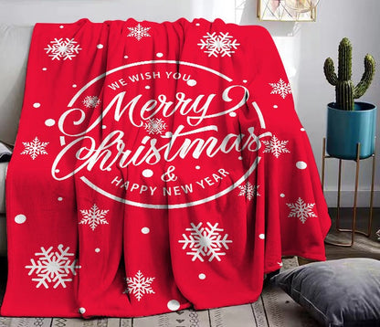 Fleece kerstplaid met kerstprint over een bank - rood met merry christmas-krans