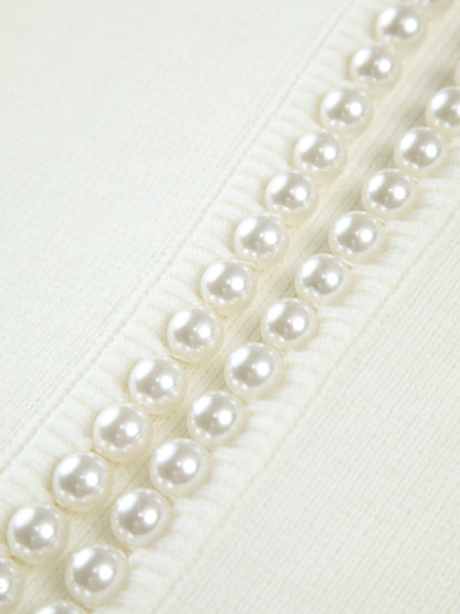 Kort damesvest met ronde hals, parelrand en ballonmouwen