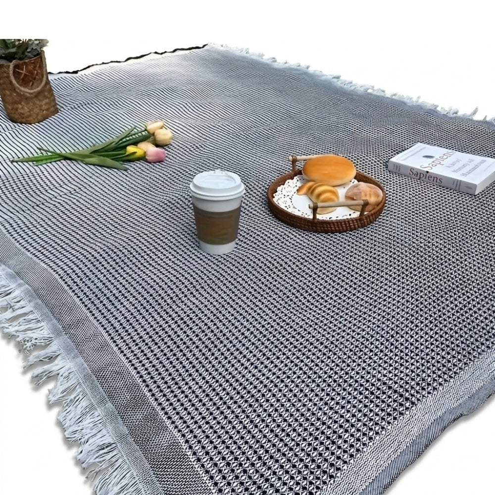 Picknickkleed van 180 x 180 cm met wafelstructuur en franjes op het gras - zwart met wit