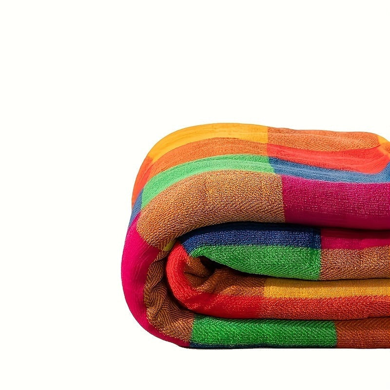 Sherpa plaid met kleurrijk ruitpatroon over een bed - beeld 5