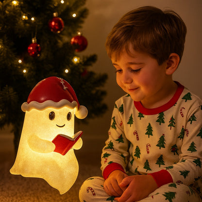 Wit spooklampje met rode kerstmuts en belletje dat een rood boek vasthoudt en warm geel oplicht