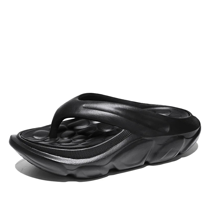 Teenslippers van EVA met dikke zool, voetbed met kiezelvormige noppen en brede band - zwart