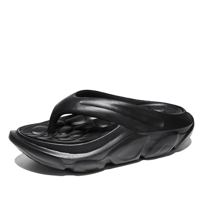 Teenslippers van EVA met dikke zool, voetbed met kiezelvormige noppen en brede band - zwart