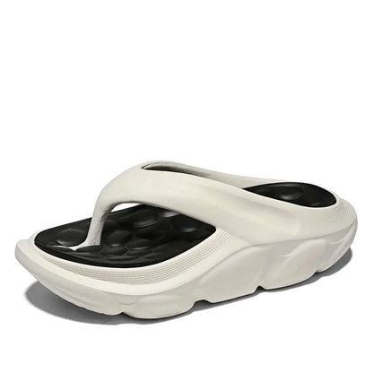 Teenslippers van EVA met dikke zool, voetbed met kiezelvormige noppen en brede band - wit/zwart